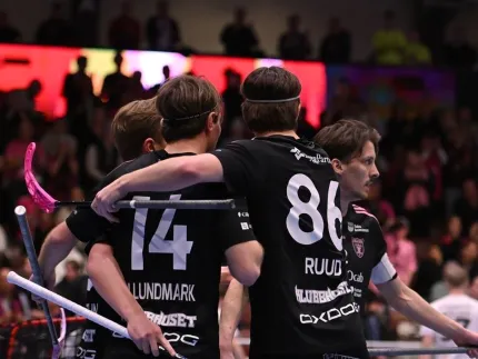 Innebandyspelare som kramar om varandra.