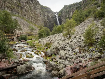 Block terrain, a wooden bridge, a waterfall in the distance.