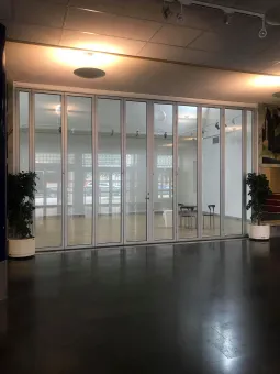 Many windows and black floor.