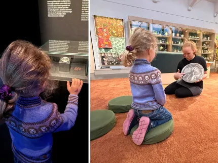 Ett barn tittar i en monter och sitter på en kudde medan en museiguide visar ett stort mynt i en utställningssal..