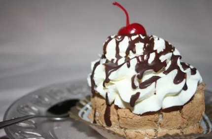 A creamy pastry with a cherry on top