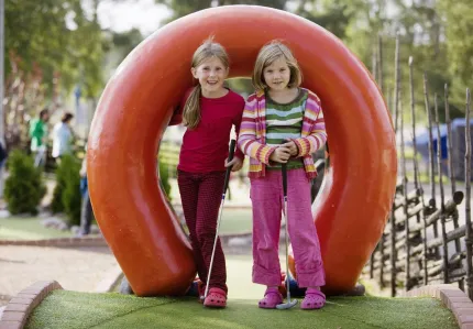 Two girls playing golf.