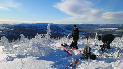 Skidåkare i snön med en fin vy på fjället. 