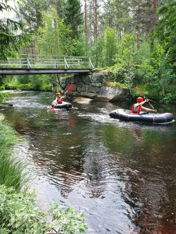 Two pack rafters in a stream.